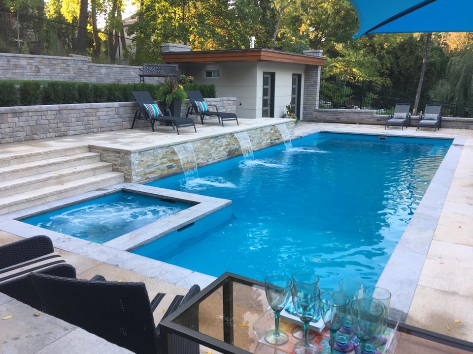 a rectangular fiberglass swimming pool with built-in spa